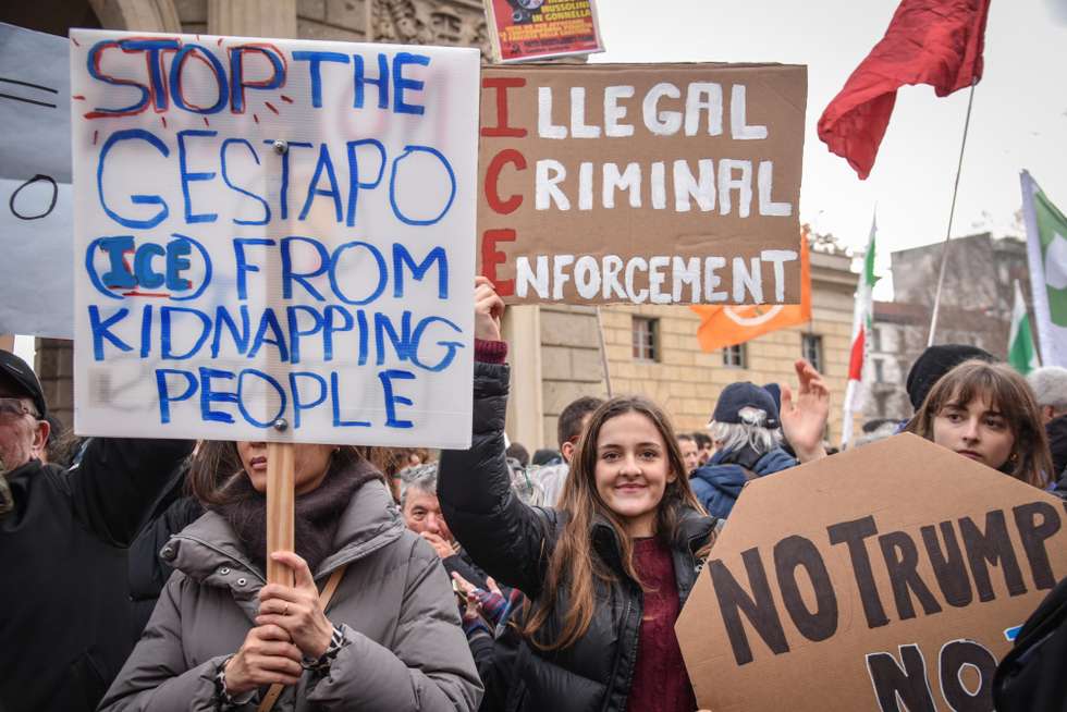 epa12695024 Demonstrators take part in a 'No ICE' protest in Milan, northern Italy, 31 January 2026, against the planned presence of US Immigration and Customs Enforcement (ICE) agents during the Milan-Cortina 2026 Winter Olympics. Protesters are criticizing the agency's security role following recent controversial fatal shootings involving federal agents in the United States.  EPA/MATTEO CORNER