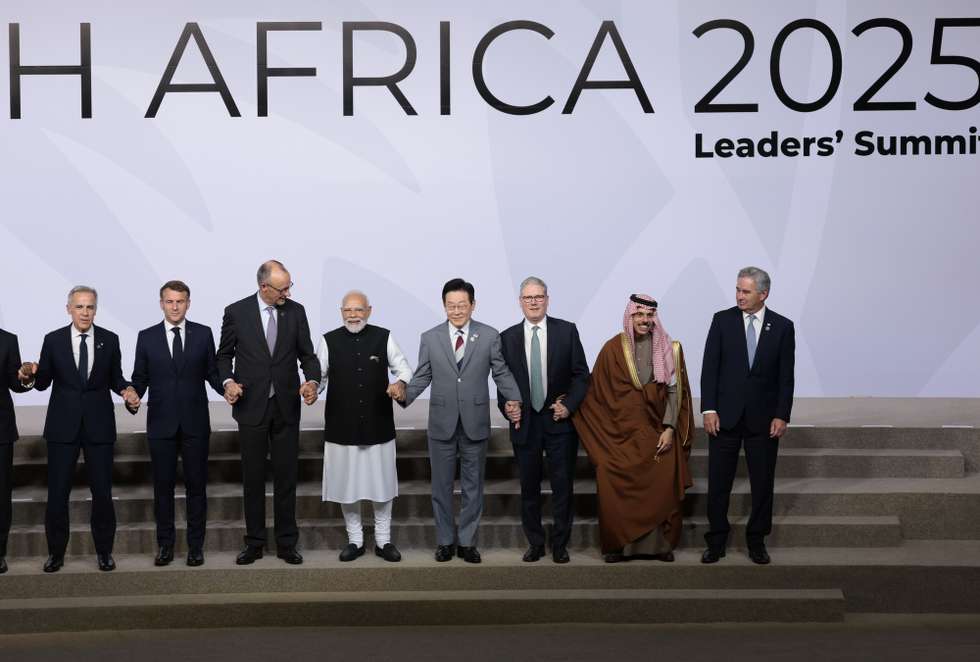 epa12541826 (L-R) Canada's Prime Minister Mark Carney, France's President Emmanuel Macron, Germany's Chancellor Friedrich Merz, India's Prime Minister Narendra Modi, South Korea's President Lee Jae Myung, British Prime Minister Keir Starmer, Saudi Arabia's Foreign Minister Faisal bin Farhan Al Saud, and Argentina's Foreign Minister Pablo Quirno stand for a family photo on the first day of the G20 Leaders' Summit at the Nasrec Expo Centre in Johannesburg, South Africa, 22 November 2025. World leaders are gathering in South Africa, the host of this year's G20 Leaders' Summit on 22 and 23 November 2025, to discuss the global economy, development and financing.  EPA/YVES HERMAN / POOL