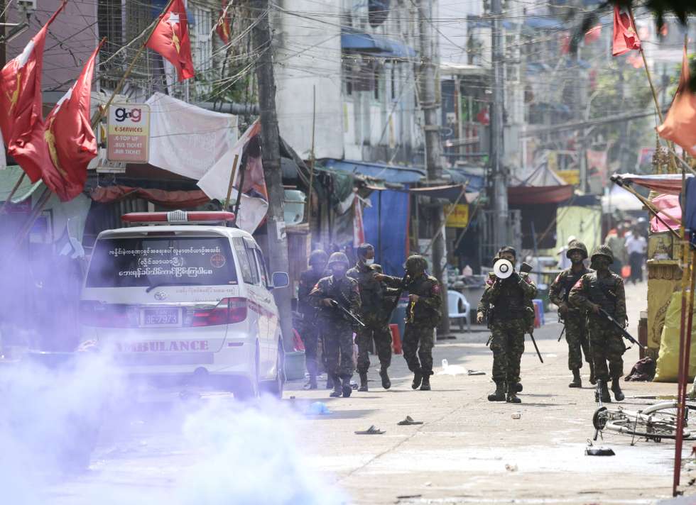 epa09047931 Soldiers give warnings as they advance to disperse protesters during a protest against the military coup in Yangon, Myanmar, 03 March 2021. Foreign ministers of the Association of Southeast Asian Nations (ASEAN) called for a halt of violence during a meeting on 02 March as protests continued amid rising tension in the country between anti-coup protesters and security forces.  EPA/LYNN BO BO