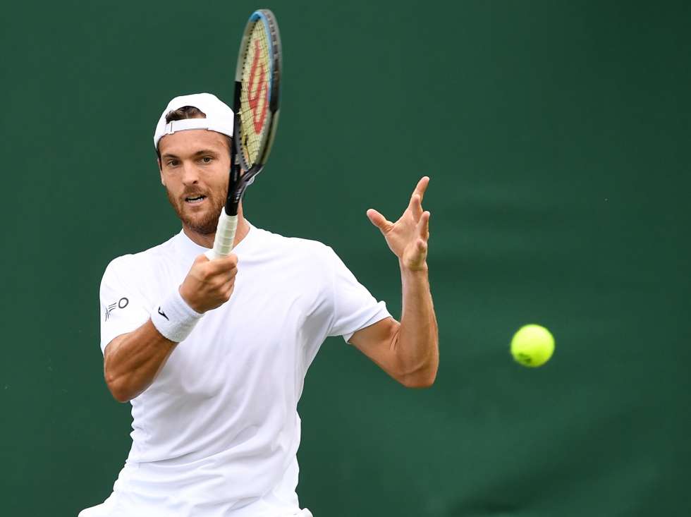 epa09308409 Joao Sousa of Portugal in action against Andreas Seppi of Italy during the 1st round match at the Wimbledon Championships, Wimbledon, Britain 28 June 2021.  EPA/FACUNDO ARRIZABALAGA