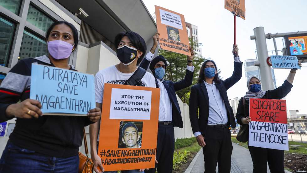 epa09903887 Activists hold placards against the planned execution of Nagaenthran K. Dharmalingam, who was convicted of a drug offence 11 years ago in Singapore but diagnosed as intellectually disabled, outside the Singapore embassy in Kuala Lumpur, Malaysia, 23 April 2022. Nagaenthran was arrested on 22 April 2009 at the Singapore-Malaysia Woodland border checkpoint and charged for trafficking 42.72 grams of diamorphine (heroin). Nagaenthran is scheduled to be executed on 27 April 2022 in Singapore.  EPA/FAZRY ISMAIL