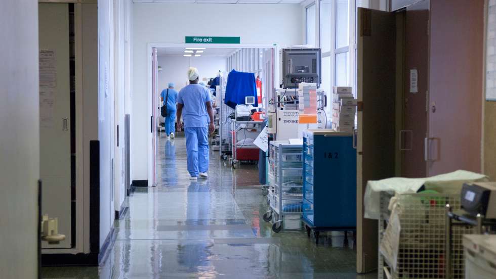 Hospital corridor with staff.