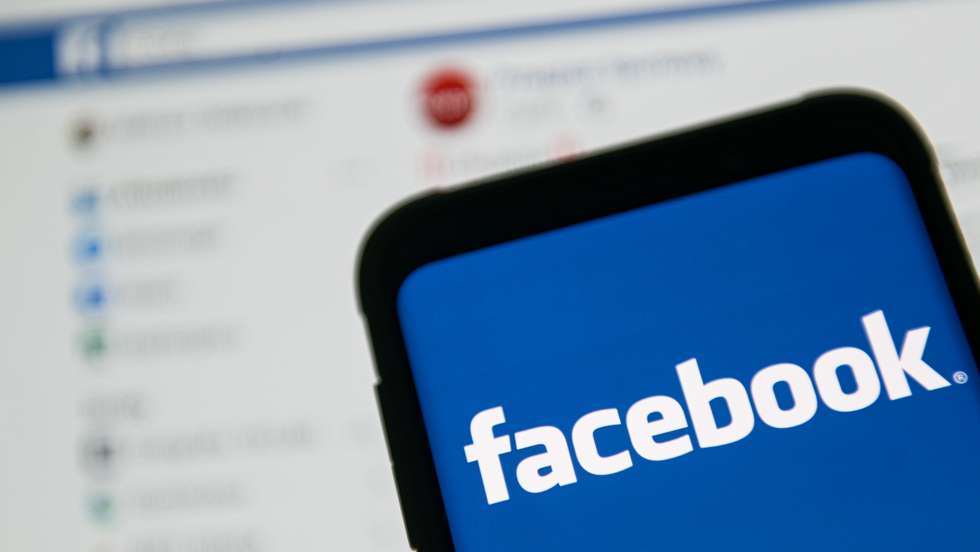 In this photo illustration a Facebook logo seen displayed on