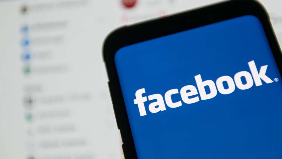 In this photo illustration a Facebook logo seen displayed on