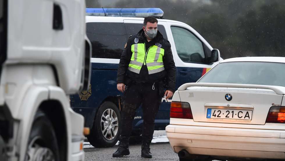 Border police officer inspects a vehicle at a checkpoint