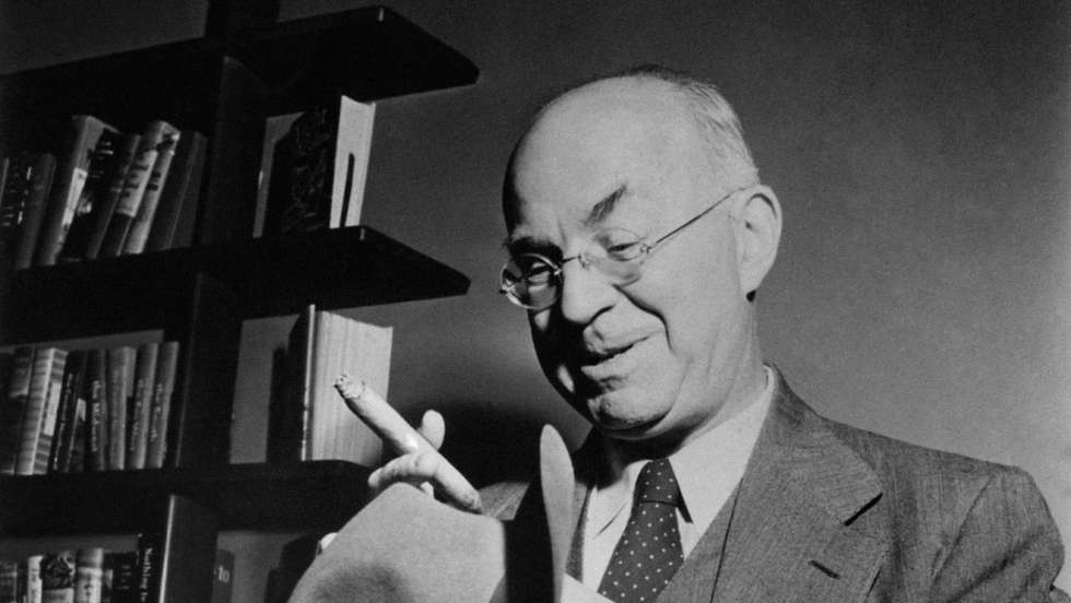 American writer and journalist John Dos Passos smoking a cigar holding a hat in his hands. 1960s. (Photo by Mondadori via Getty Images)