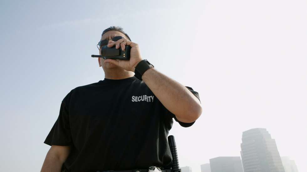 Security Guard Talking on Walkie-talkie