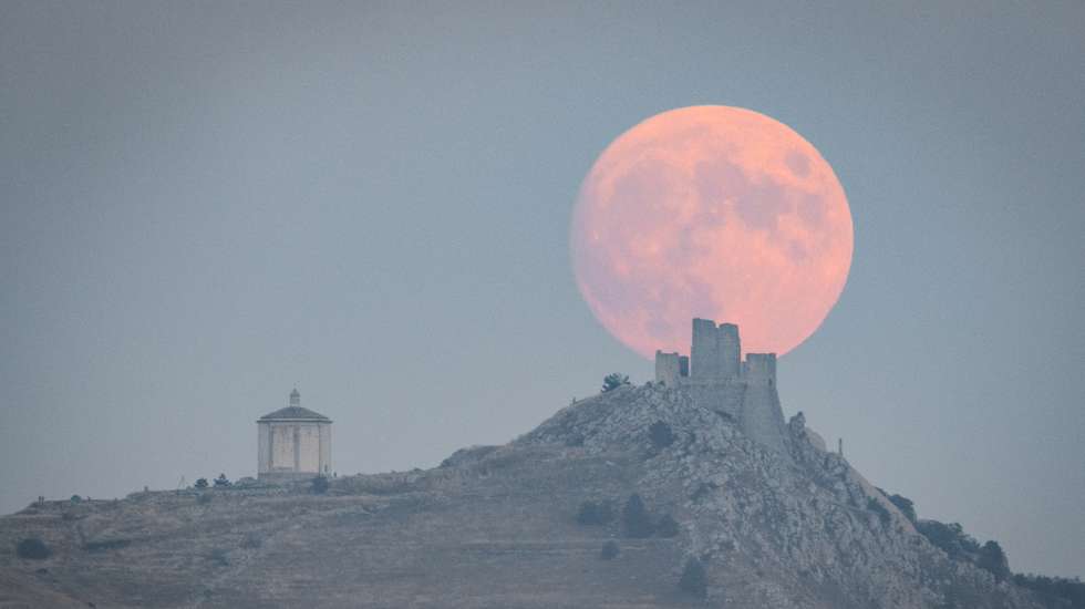 Full harvest moon rising behind Rocca Calascio castle and Santa Maria della Pietà church is seen in Calascio (L'Aquila, Abruzzo), Italy, on September 28, 2023. Harvest Moon is the full moon that occurs closest to the autumnal equinox. It is a supermoon, which means that it will appear larger and brighter than usual and is last 2023 super moon. (Photo by Lorenzo Di Cola/NurPhoto via Getty Images)