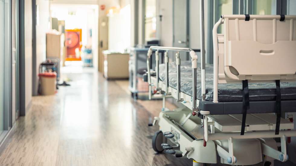 Empty hospital beds in hospital corridor