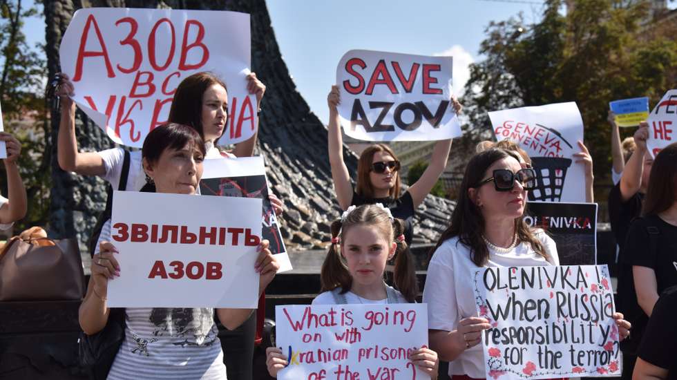 Protesters hold placards calling for the release of captured