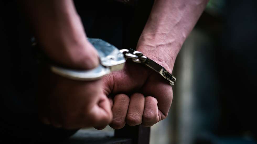 Cropped Hand Of Handcuffs
