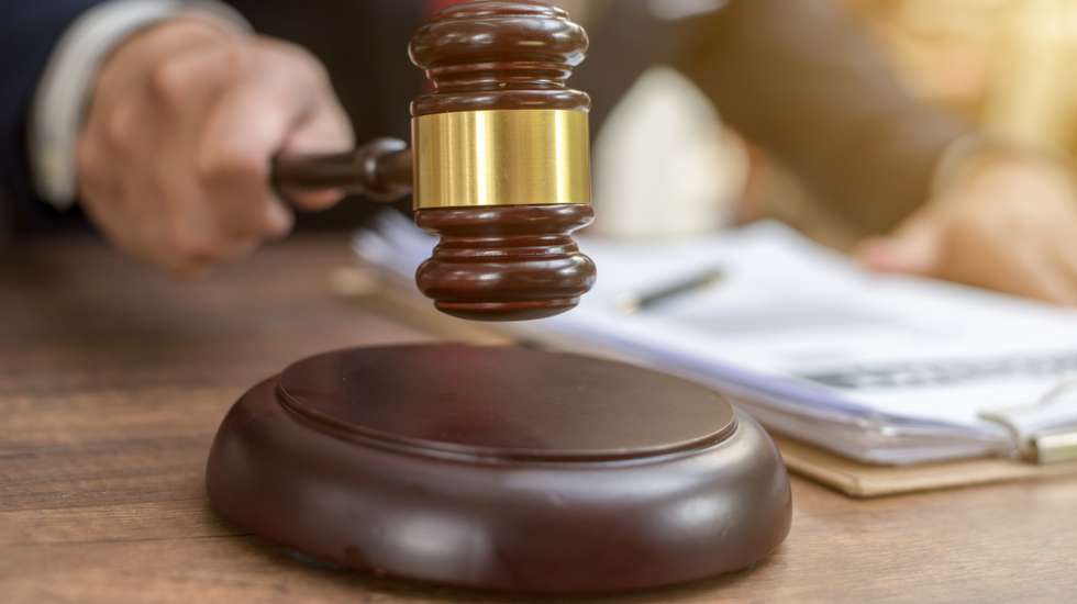Close up lawyer businessman working or reading lawbook in office workplace for consultant lawyer concept.