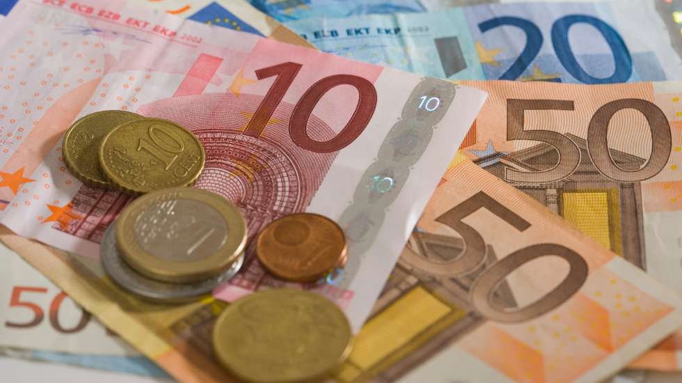 "Euro coins and notes fanned out, in studio"