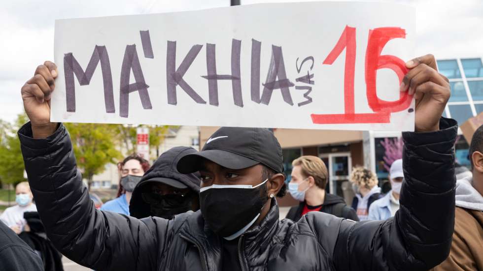 Black Lives Matter activist holds a placard protesting the