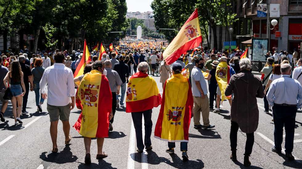 Protesters march on Genova Street, ahead is Colon square