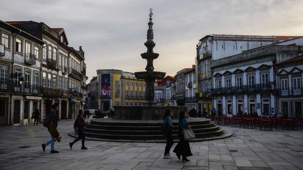 People are seen walking by Republic Square