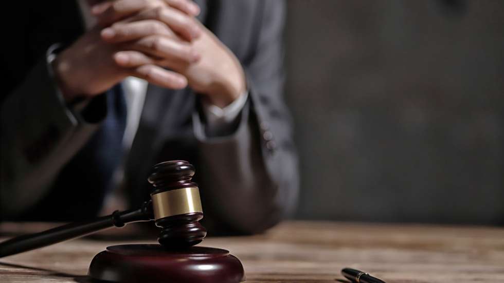 Close-Up Of Lawyer Sitting At Table