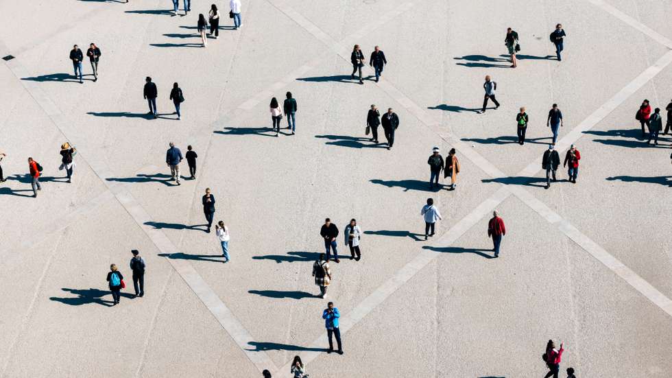 Aerial view of large number of people walking on the city square on the sunny day