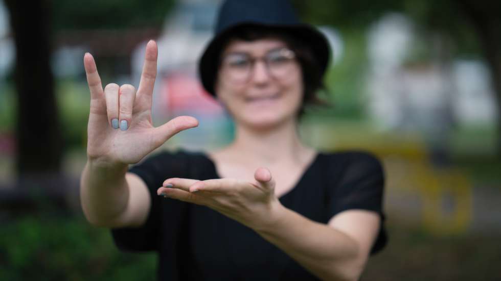Young woman showing a sign