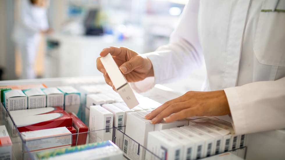 Pharmacist organizing the medicine drawer