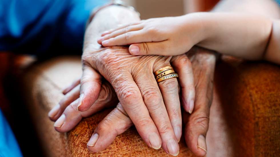 Elderly couple and baby&#039;s hand, generations together