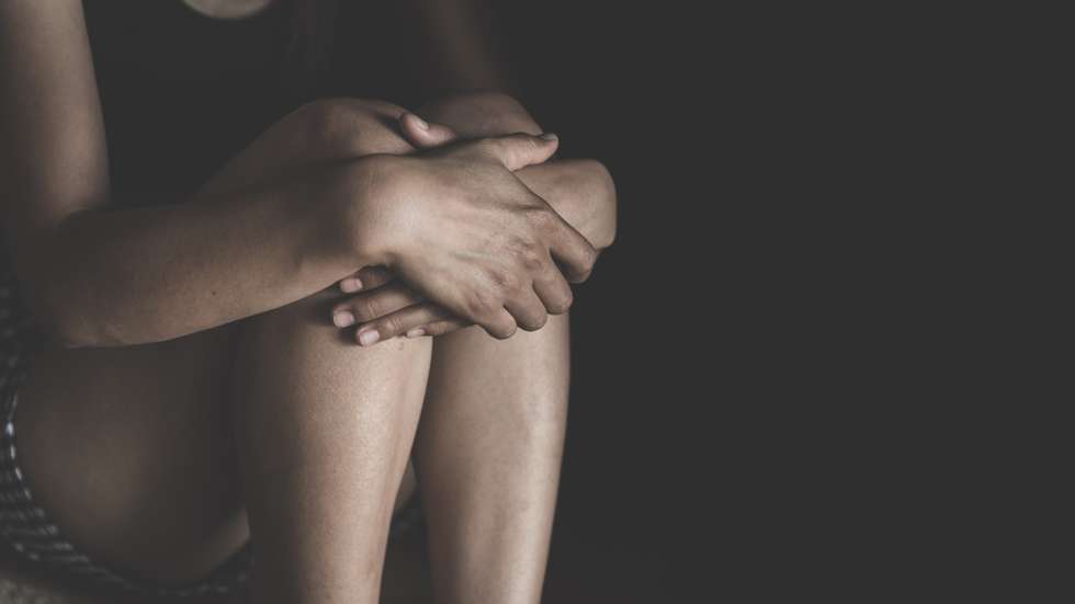 Woman lying on the floor crying with depression