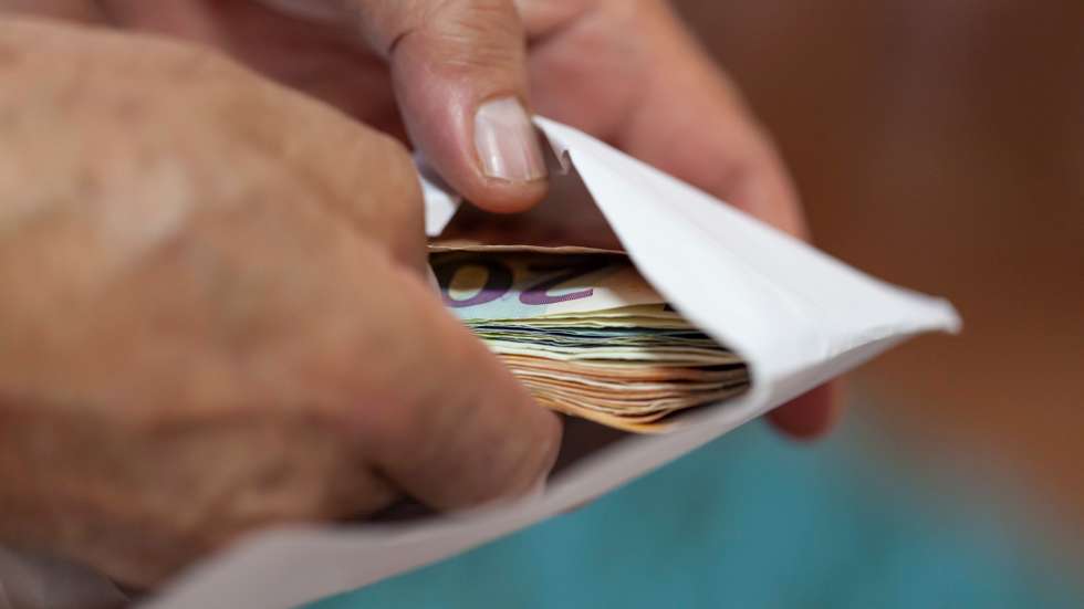 Putting money in an envelope
