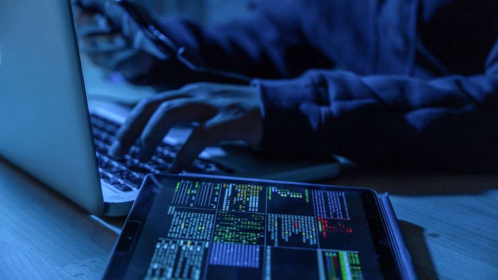 Payments System Hacking. Online Credit Cards Payment Security Concept. Hacker in Black Gloves Hacking the System.