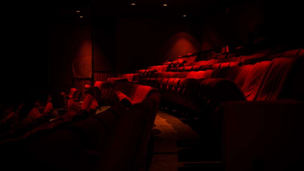 Photograph of the red seats of a former large abandoned theater and cinema