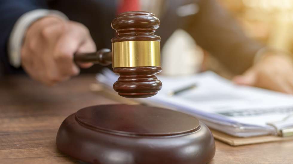 Close up lawyer businessman working or reading lawbook in office workplace for consultant lawyer concept.