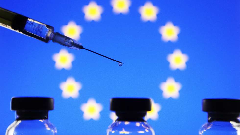 In this photo illustration the vials and a medical syringe