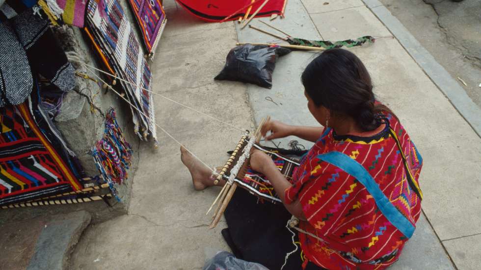 Woman weaving at indigenous market, Oaxaca