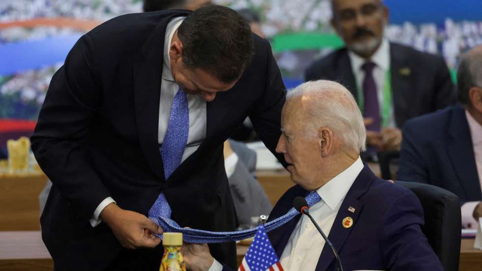 Fotografia da Reuters mostra Biden e Montenegro focados nas gravatas de ambos, que têm uma cor e um padrão muito semelhantes