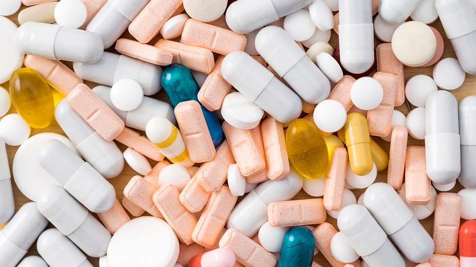 Full frame heap of various colors pills and capsules, close-up