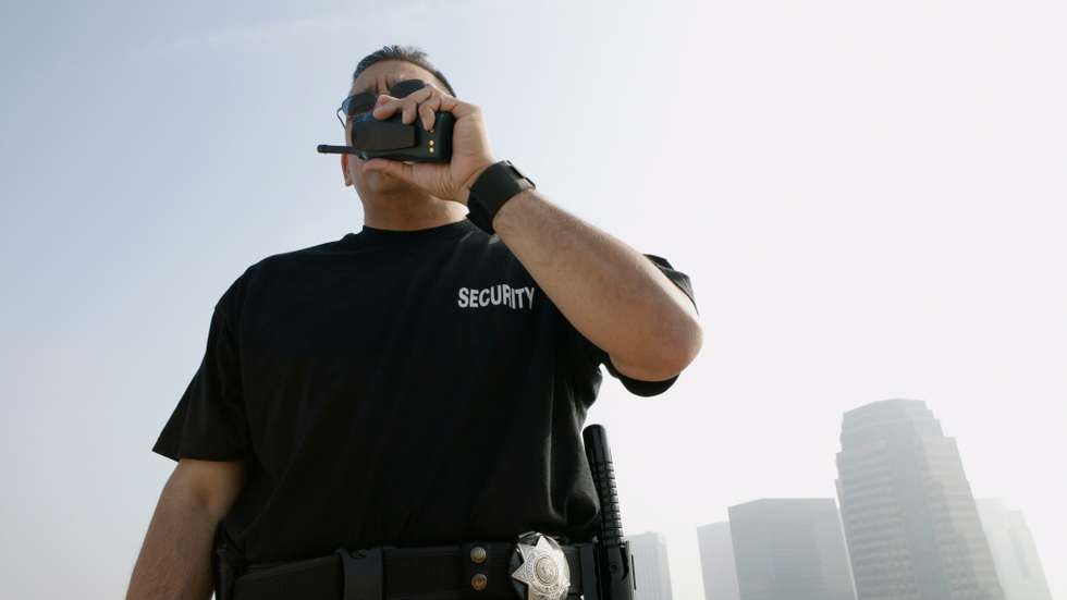 Security Guard Talking on Walkie-talkie