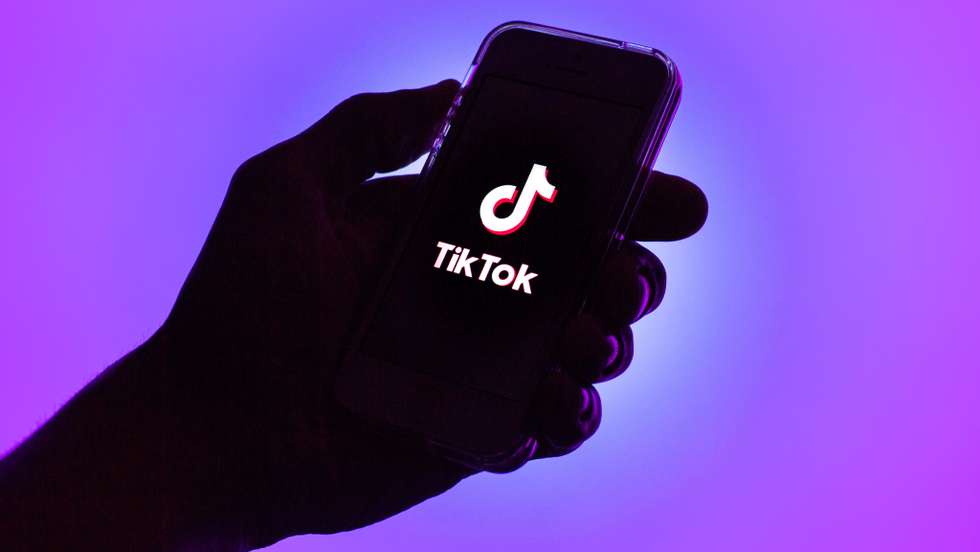 In this photo illustration, a Tik Tok logo seen displayed on