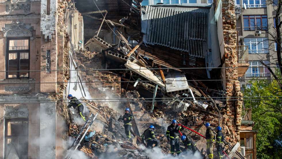 Ukrainian rescuers work at the site of a residential