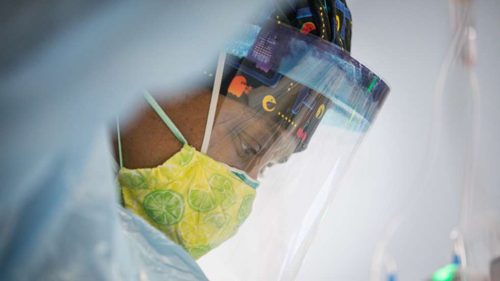 A Nurse in a Face Shield Tends to a COVID-19 Patient at a Hospital on Long Island, New York