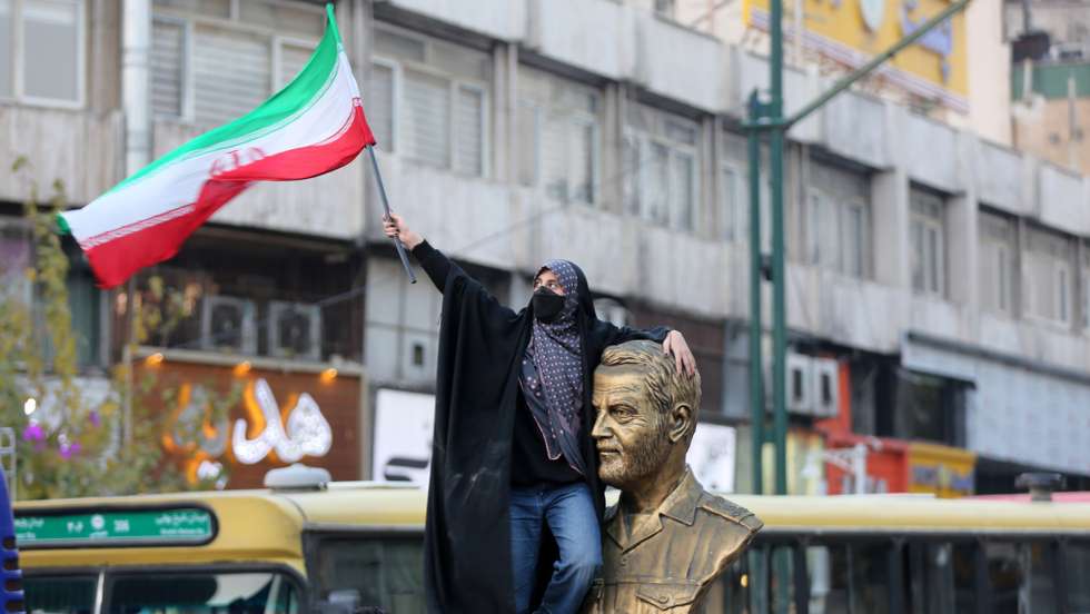 People celebrate after Iran's win against Wales