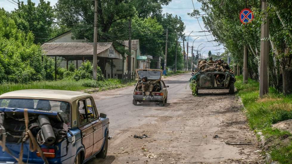 Soldiers seen moving on a tank and vehicles in the outskirts