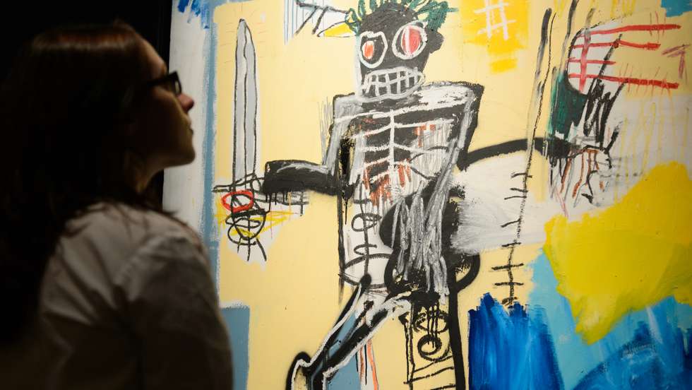 A gallery assistant poses with US artist