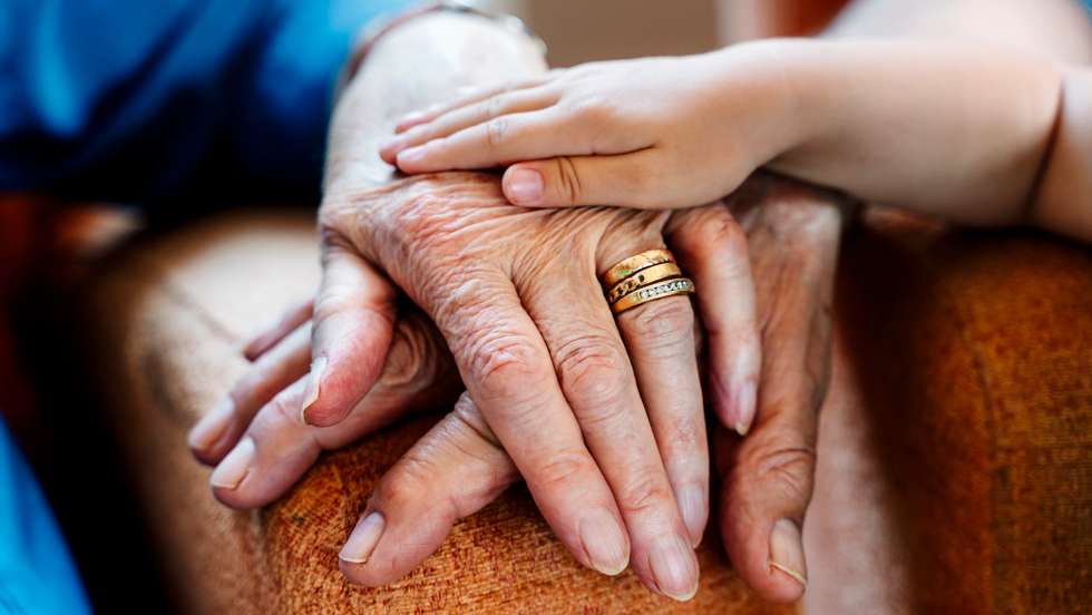 Elderly couple and baby&#039;s hand, generations together