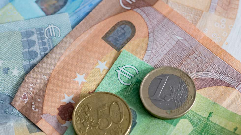 photo illustration: Euro banknotes with coins