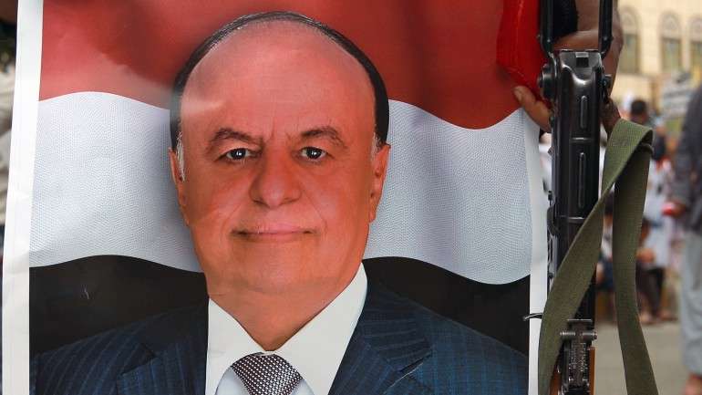Um cartaz com a imagem de Abdrabhu Mansur Hadi