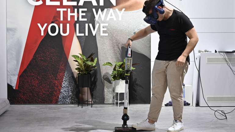 Um dos voluntários da IFA a limpar o chão com um novo aspirador enquanto utiliza óculos de realidade aumentada. A IFA 2019 decorre de 6 a 11 de setembro