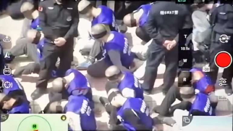 Imagens mostram os prisioneiros ajoelhados e com coletes que identificam um centro de detenção