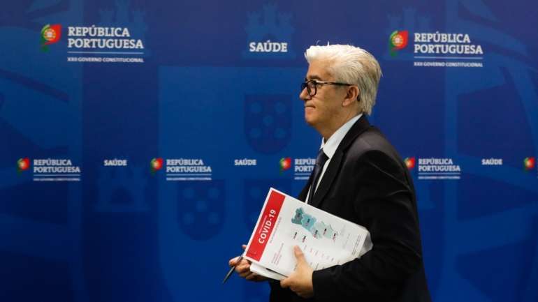 Secretário de Estado da Saúde com um dos exemplares de boletim que a DGS divulga diariamente sobre a situação epidemiológica no país.