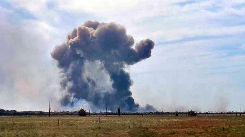 epa10112853 A handout picture made available by the Department of Information and Press Service of the Head of the Republic of Crimea shows smoke rising after detonations of air munisions at the Saki airfield near the Novofedorovka settlement, Crimea, 09 August 2022. Violation of the fire safety rules is being probed as the main cause of the explosion of ammunition at the Saki airfield in Crimea; there is no sign that they were blown up intentionally, a source at the Russian Defense Ministry said.  EPA/Press Office of Head of Crimea HANDOUT MANDATORY CREDIT HANDOUT EDITORIAL USE ONLY/NO SALES