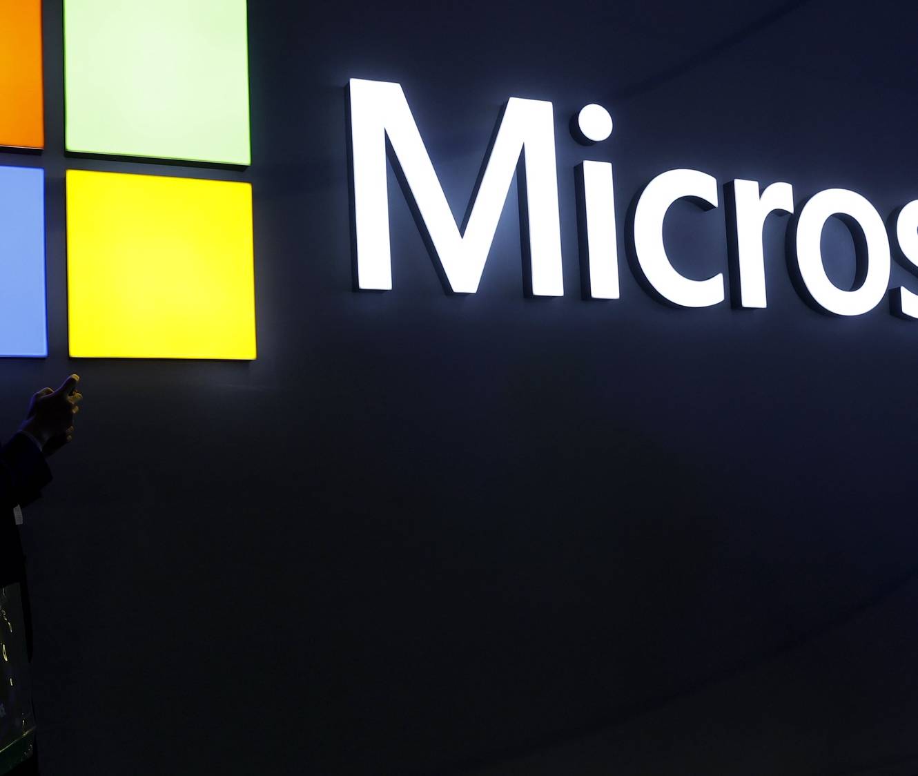 epa11184330 Two visitors walk in front of Microsoft stand during the second day of the MWC (Mobile World Congress) 2024 in Barcelona, Catalonia, north-eastern Spain, 27 February 2024. MWC Barcelona, the largest event for the connectivity ecosystem, will run from 26 to 29 February.  EPA/TONI ALBIR