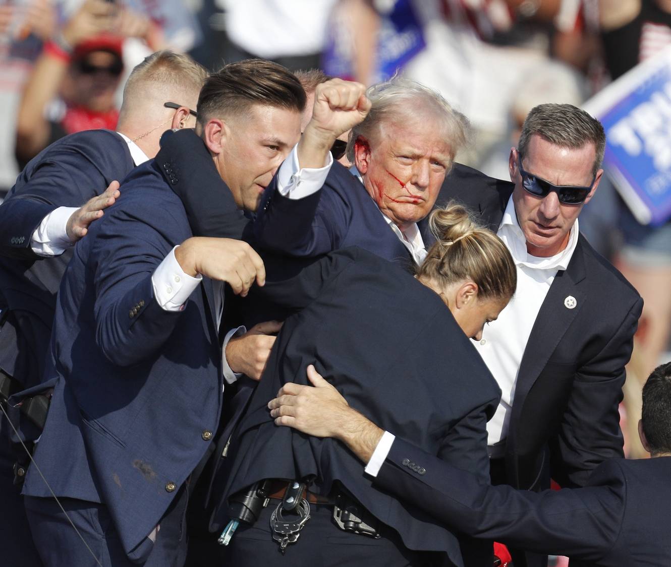 epa11476746 Former US President Donald Trump is rushed off stage by secret service after an incident during a campaign rally at the Butler Farm Show Inc. in Butler, Pennsylvania, USA, 13 July 2024.  EPA/DAVID MAXWELL